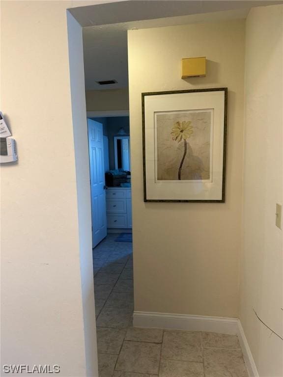 hallway featuring light tile patterned floors