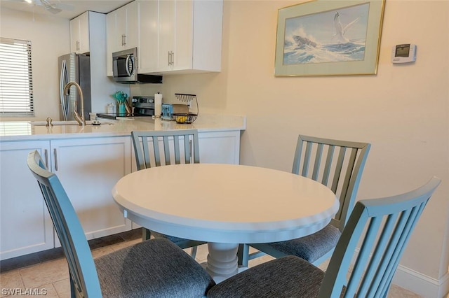 dining room with sink and light tile patterned floors