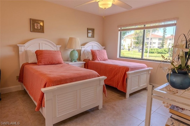 tiled bedroom featuring ceiling fan