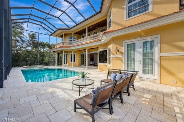 view of pool with a patio area, french doors, and glass enclosure