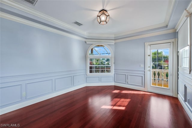 unfurnished room featuring ornamental molding and dark hardwood / wood-style flooring