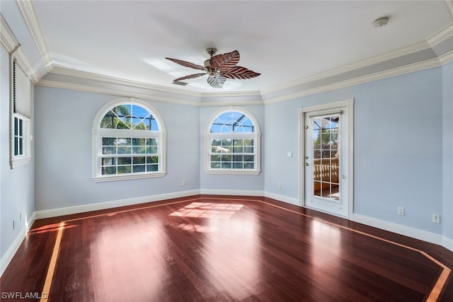 unfurnished room featuring ornamental molding, ceiling fan, a healthy amount of sunlight, and dark wood-type flooring