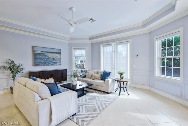 living room with ornamental molding, a healthy amount of sunlight, and ceiling fan