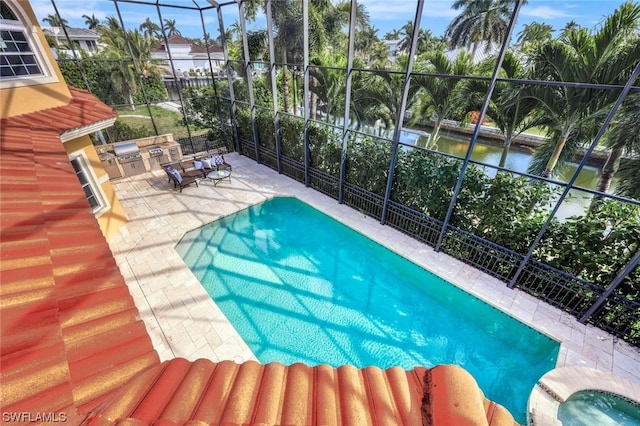 view of pool with a patio and glass enclosure