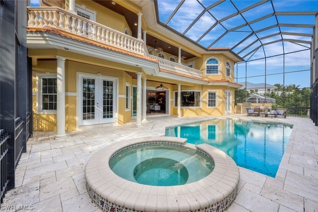 view of swimming pool with french doors, an in ground hot tub, and a patio area