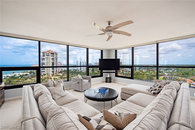 carpeted living room featuring ceiling fan and a wealth of natural light