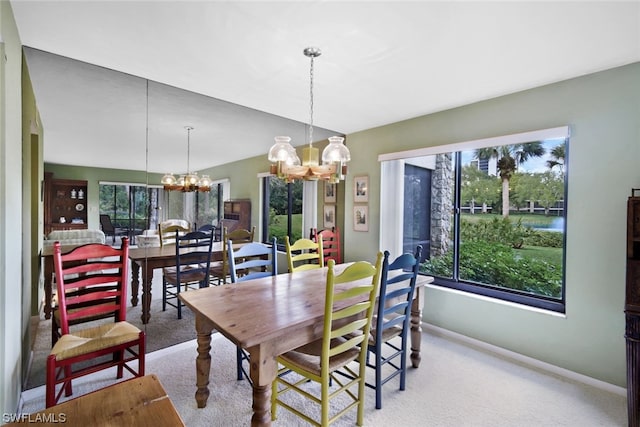 carpeted dining space with a notable chandelier