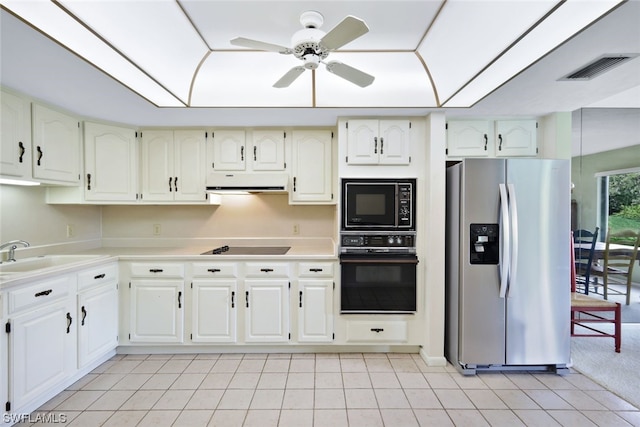 kitchen featuring ceiling fan, sink, black appliances, light tile patterned floors, and white cabinetry