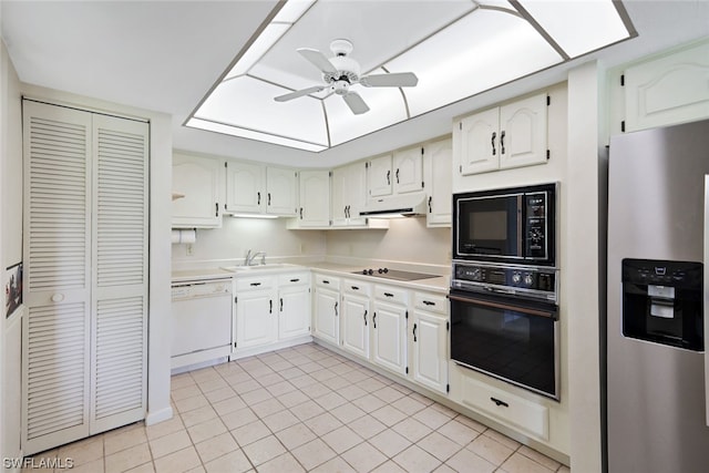 kitchen featuring light tile patterned floors, white cabinetry, and black appliances