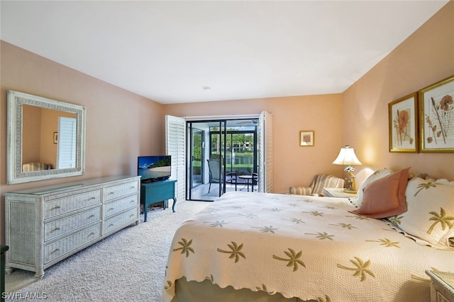 bedroom featuring light colored carpet and access to outside