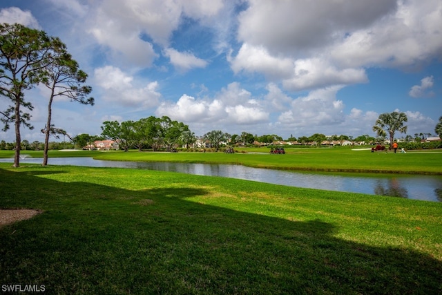 surrounding community with a yard and a water view