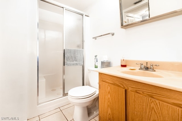 bathroom featuring vanity, tile flooring, a shower with shower door, and toilet