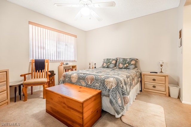 bedroom with light carpet, a textured ceiling, and ceiling fan