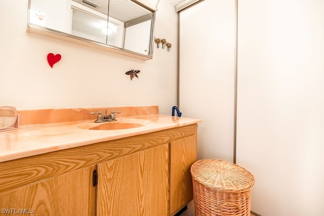 bathroom featuring vanity with extensive cabinet space