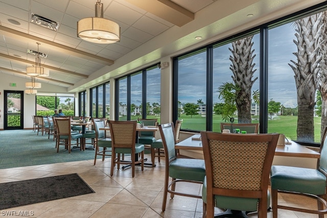 dining space with light tile floors and lofted ceiling