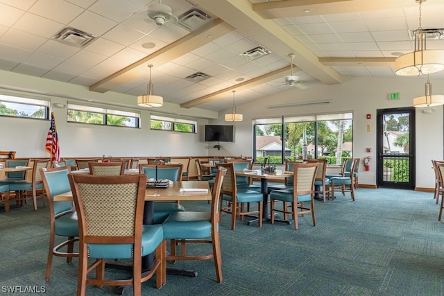 carpeted dining space with plenty of natural light, ceiling fan, and vaulted ceiling with beams