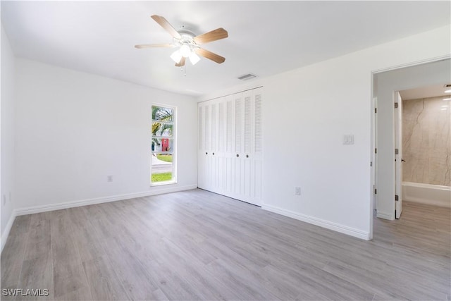 unfurnished bedroom featuring ceiling fan, a closet, and light hardwood / wood-style flooring