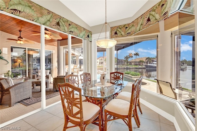 tiled dining space with lofted ceiling and ceiling fan