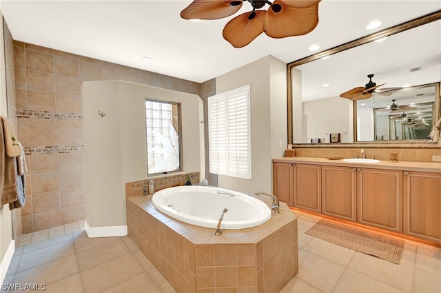 bathroom with ceiling fan, tile floors, a relaxing tiled bath, and vanity