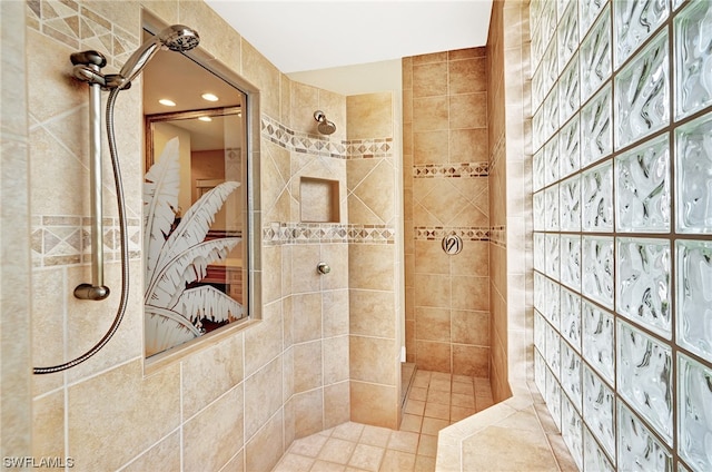 bathroom featuring tile walls and tiled shower