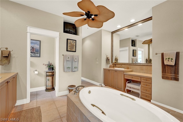 bathroom featuring tile floors, a relaxing tiled bath, vanity, and ceiling fan