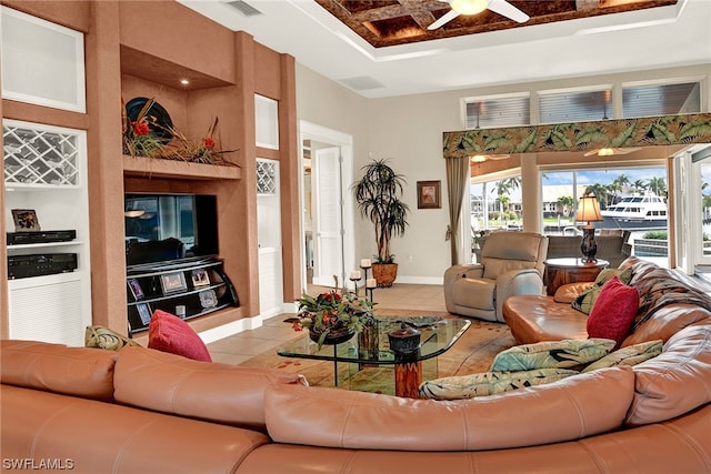 living room featuring light tile floors, ceiling fan, and built in features