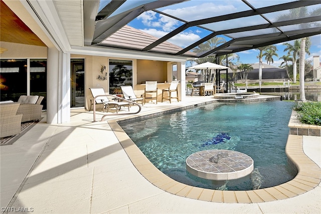 view of swimming pool featuring a patio area and glass enclosure