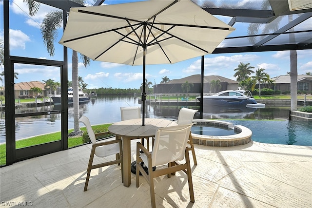 exterior space featuring a water view, a patio, a swimming pool with hot tub, and a lanai