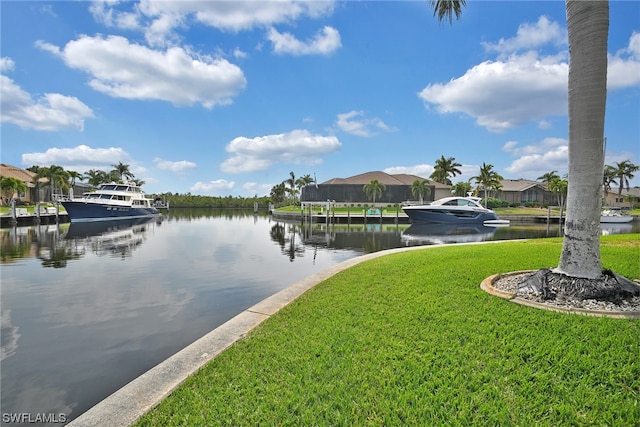 dock area featuring a lawn and a water view