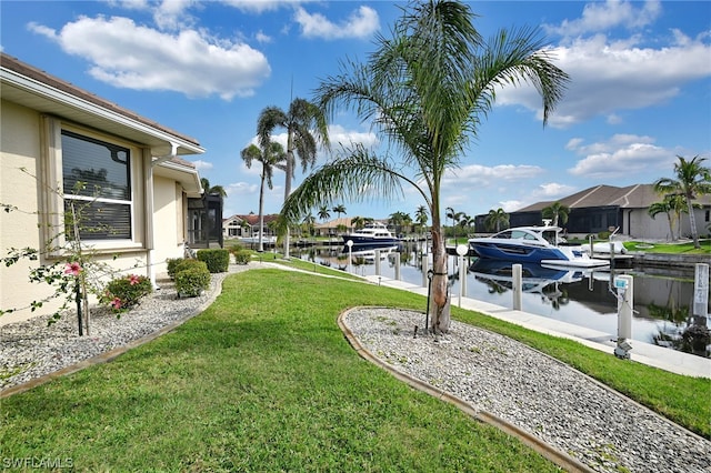 view of yard featuring a water view and a boat dock