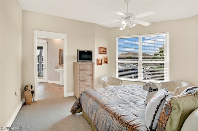 carpeted bedroom with ceiling fan and sink