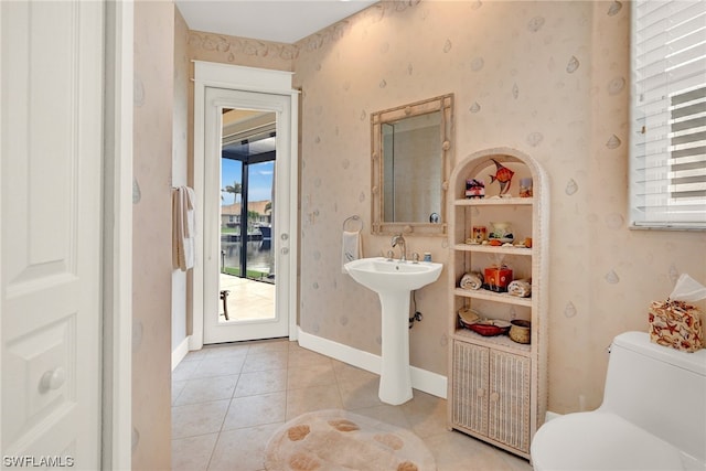 bathroom with sink, tile floors, and toilet