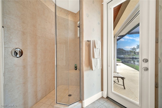 bathroom featuring tile flooring and a shower with shower door