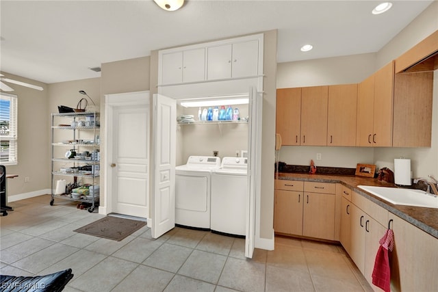 kitchen featuring ceiling fan, light tile flooring, light brown cabinets, sink, and washer and clothes dryer