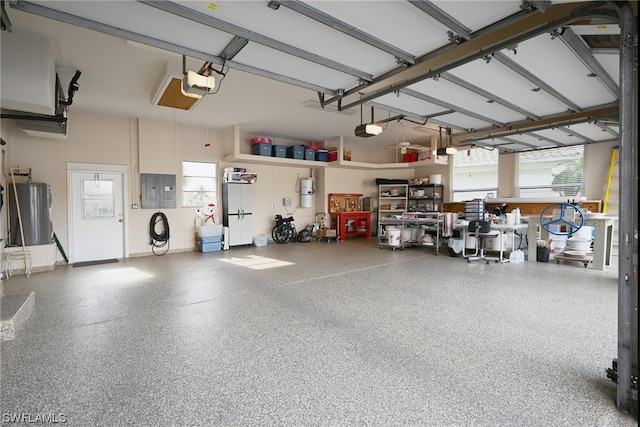 garage featuring a garage door opener and water heater