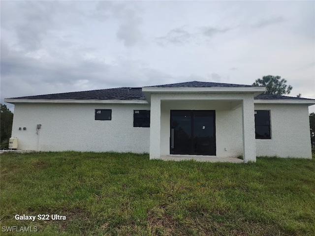 rear view of house with a lawn