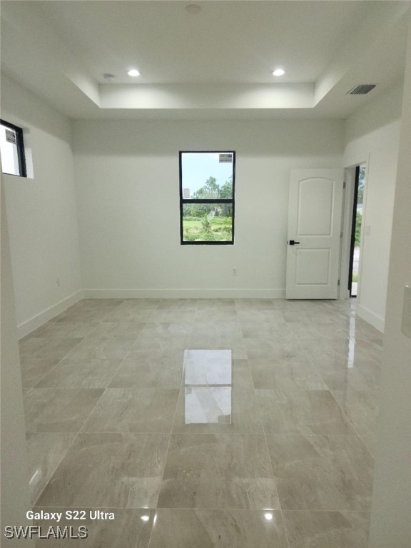 spare room featuring a raised ceiling