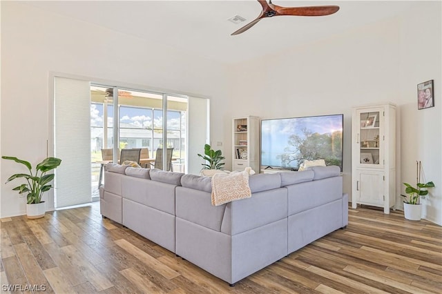 living room with ceiling fan and hardwood / wood-style floors