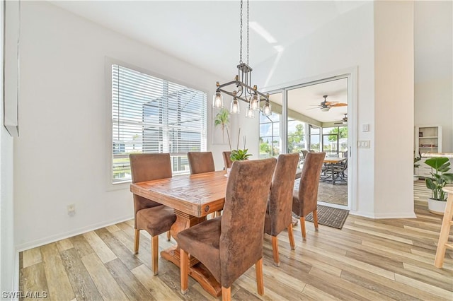 dining space featuring a notable chandelier and light hardwood / wood-style floors