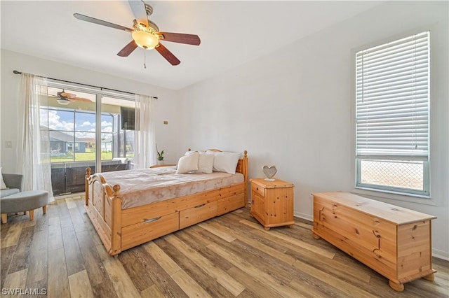 bedroom with ceiling fan, access to outside, and hardwood / wood-style floors