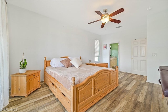 bedroom featuring ceiling fan, connected bathroom, and light hardwood / wood-style floors