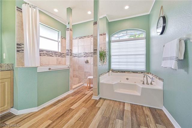 bathroom with vanity, wood-type flooring, ornamental molding, and shower with separate bathtub