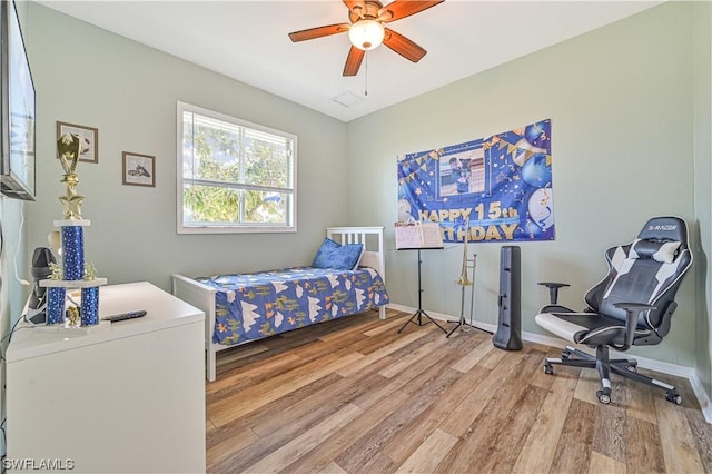 bedroom with ceiling fan and light hardwood / wood-style flooring