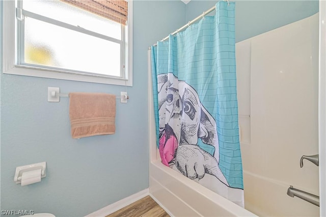 bathroom with shower / bath combo with shower curtain and hardwood / wood-style floors