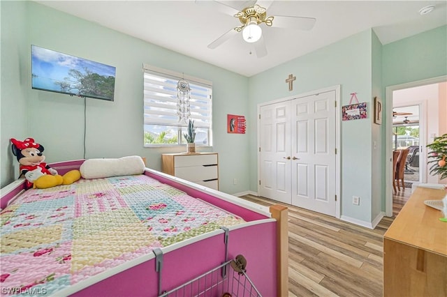 bedroom with ceiling fan, a closet, and light wood-type flooring