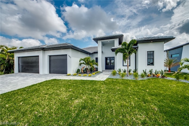 view of front of property featuring a front yard and a garage