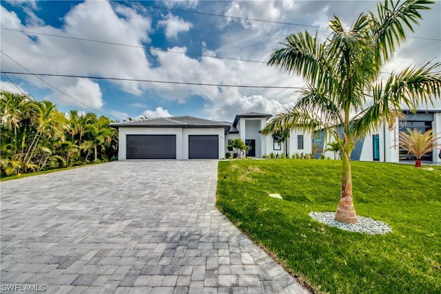 view of front of property with a front lawn and a garage