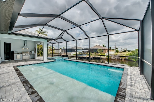 view of pool with an in ground hot tub, glass enclosure, and a patio area