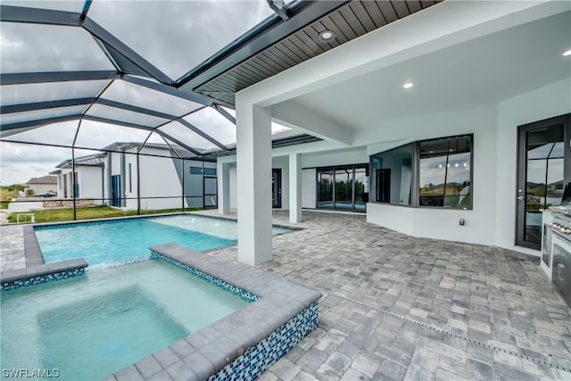 view of pool featuring an in ground hot tub, a lanai, and a patio area