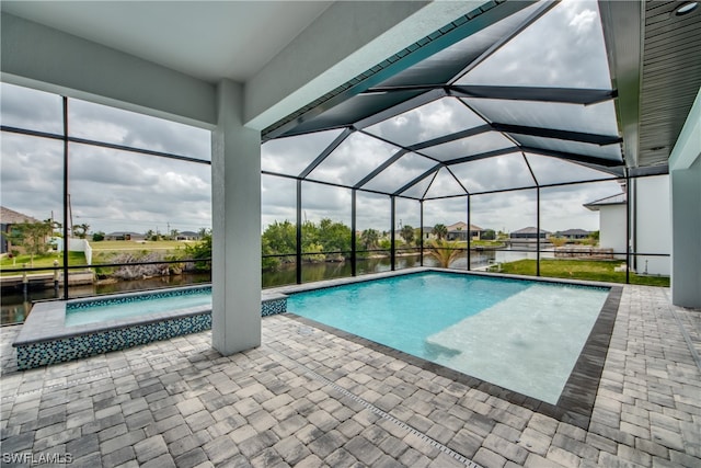 view of swimming pool featuring glass enclosure and a patio